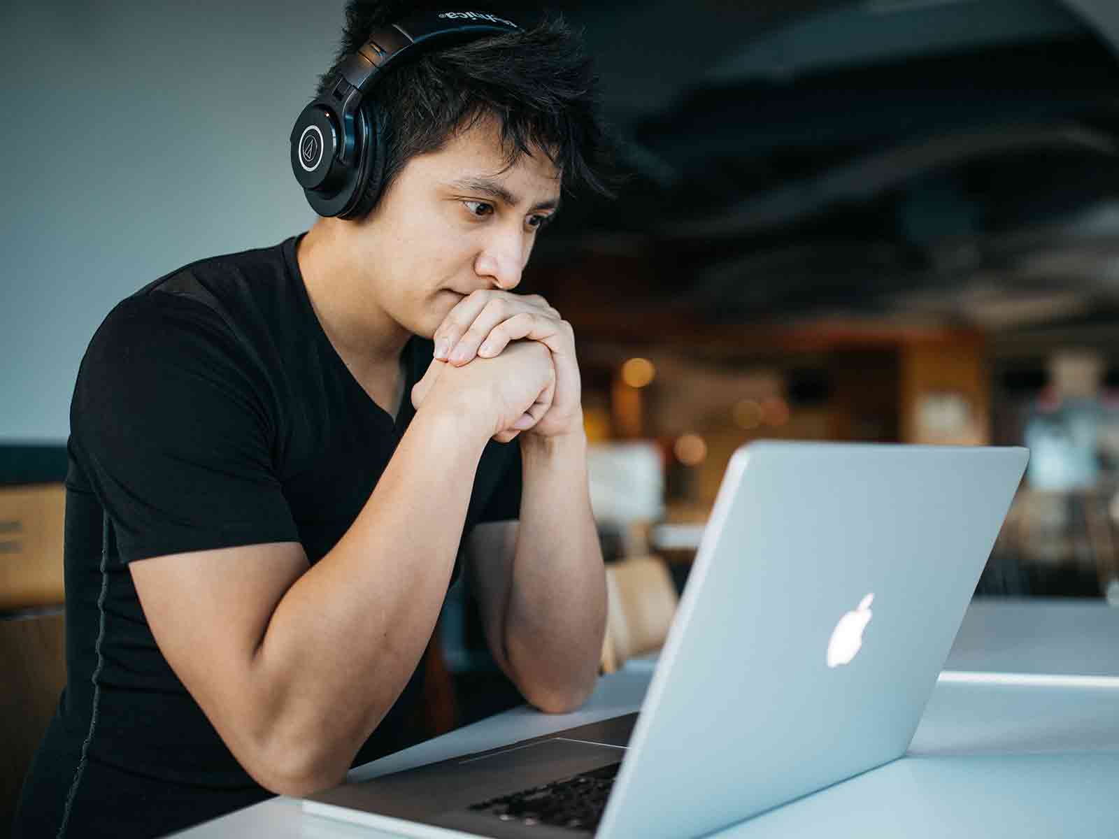 A student watching training videos on their laptop