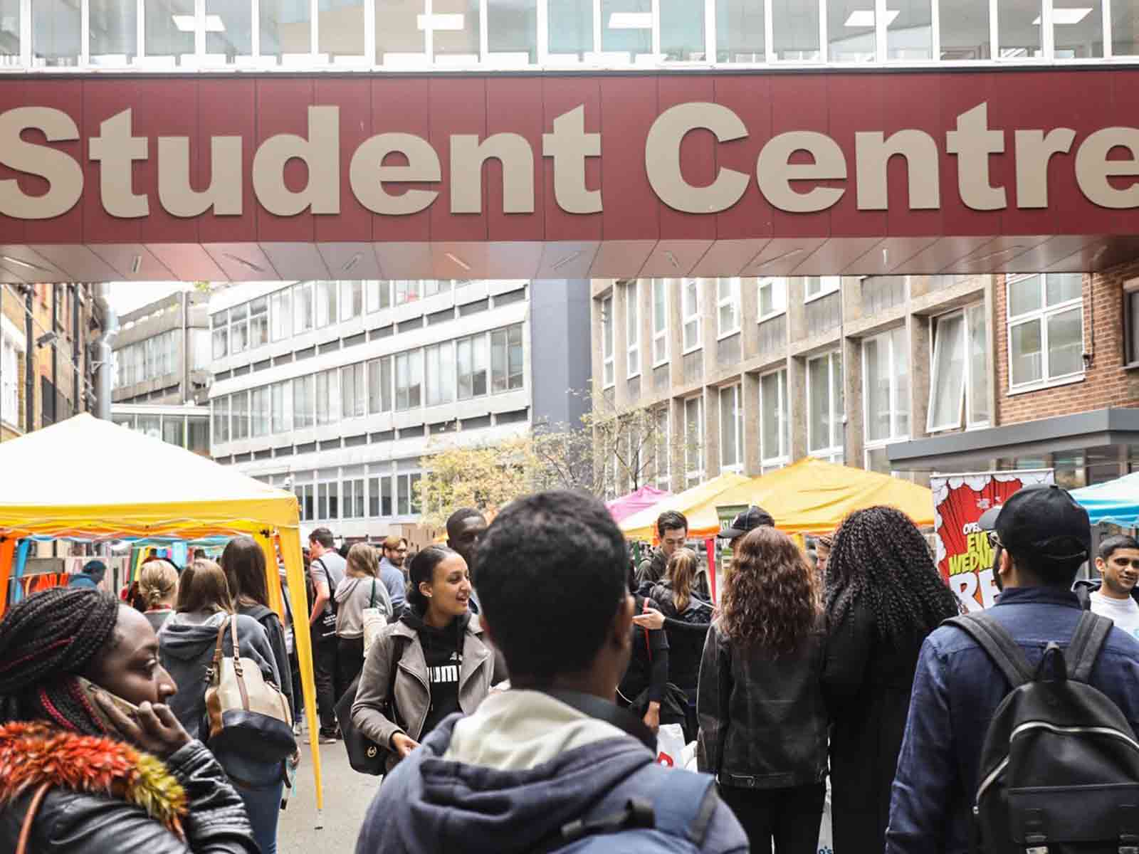 A photograph of lots of students walking through campus