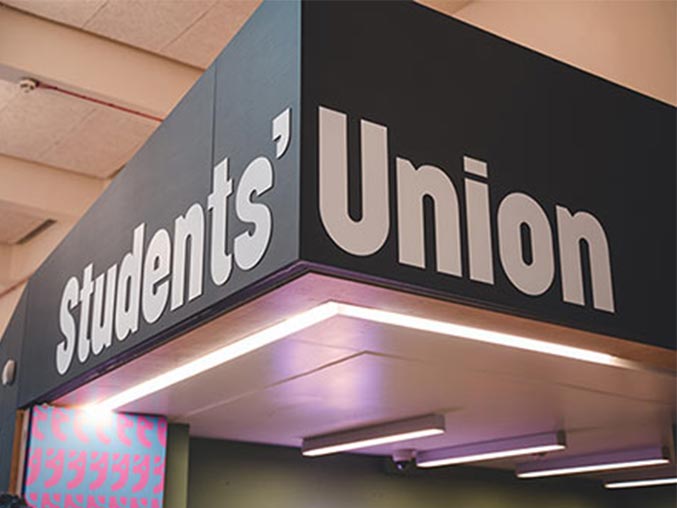 A photograph of giant letters in a campus building reading LSBSU